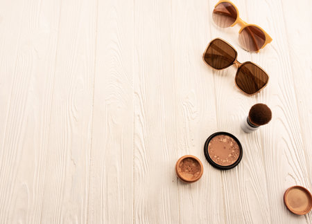 Top sunglasses beige makeup brush powder decorative cosmetic. Summer background mockup template text. top view above white wooden background Summer fashion accessories. Women summer Vacation conceptの写真素材