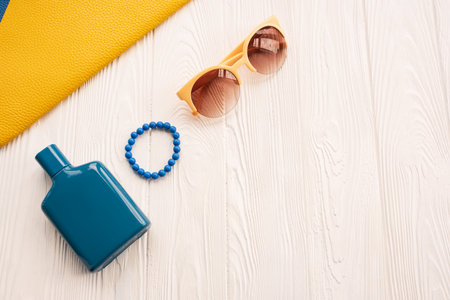 Sunglasses bijouterie bracelet clutch bag perfume jar. Summer background mockup template. top view above white wooden background. Summer fashion accessories beach. Women summer design Vacation conceptの写真素材