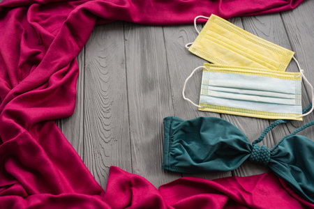 New normal covid-19 protective face virus pandemic medical mask sunglasses. turquoise swimsuit bra. Summer background template mockup free space pattern colorful composition sample text.Top view aboveの写真素材