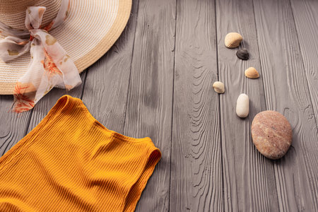 beachwear orange woman top outfit hat bag sun protection sunglasses pebbles. Summer background template mockup free space composition sample text. Top view above wooden background vacation conceptの写真素材