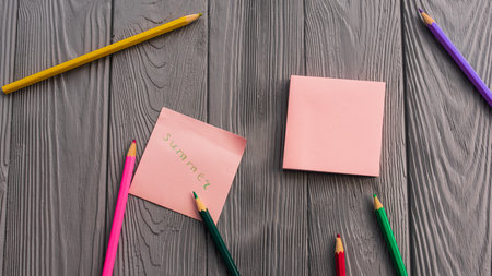 artist multicolored pencils sketch paper card inscription summer. Yellow red blue pencils. Summer background template mockup space blank colorful composition text. Top view above wooden backgroundの写真素材