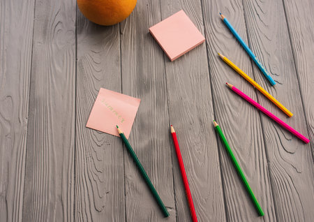artist multicolored pencils sketch paper card inscription summer. Yellow red blue pencils. Summer background template mockup space blank colorful composition text. Top view above wooden backgroundの写真素材