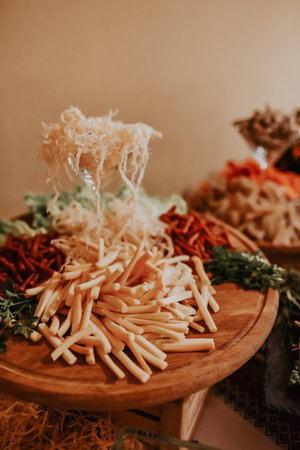 Cheese table. Delicious kinds of cheese. Buffet with cheese board. food snack party meat seafood Catering for party. Close up of sandwiches, appetizers and fruit. Canape. Christmas birthday or weddingの写真素材