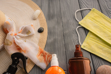New normal face mask hat bag sun protection sunglasses sunscreen spray lotion tan ultra-violet rays. Summer background template mockup free space pattern composition sample text. Top view aboveの写真素材