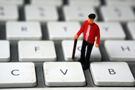 Macro photography digital divide, old man on keyboardの写真素材