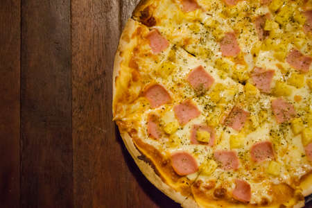 Large Pizza on wooden boardの写真素材