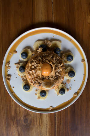 Overhead Shot Donut Cake with Granola on Wooden Table Flat Layの写真素材