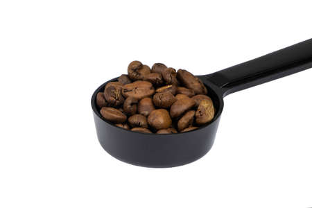 Close up on Full of Roasted Coffee Beansin the spoon isolate on white backgroundの写真素材
