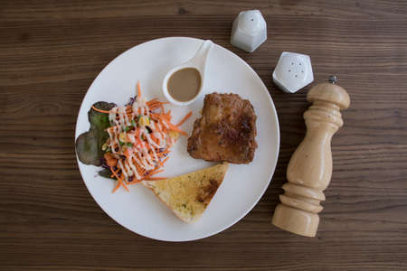 Chicken Steak with salad flat lay on wood tableの写真素材