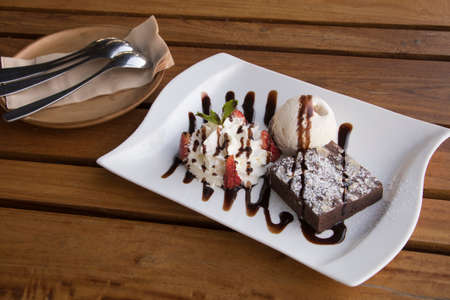 Dark Chocolate Brownie serve with Vanilla ice cream and Whip Creamの写真素材