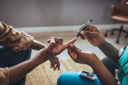 Close-up of a doctor giving a blood test to a patientの写真素材
