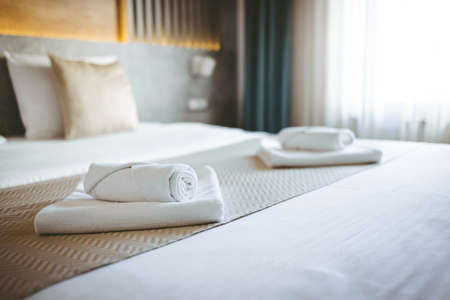 White towel on bed decoration in hotel bedroom interior - Vintage Light Filterの写真素材