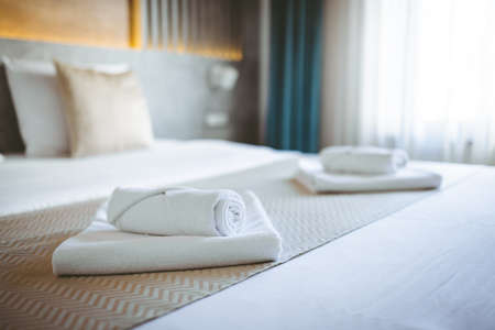 White towel on bed decoration in hotel bedroom interior - Vintage Light Filterの写真素材