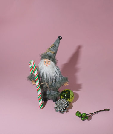 Creativ idea on a pink background with a St. Nicholas, Christmas tree  , baubles, pinecone.