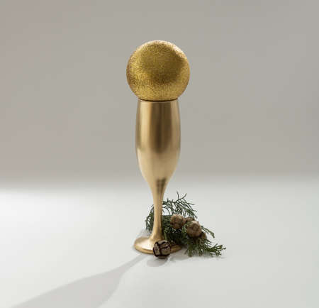Christmas tree with a golden glass of champagne. Minimal New Year's concept.の写真素材