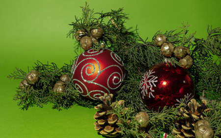 Creative arrangement on a green background. Christmas tree and red boble.の写真素材
