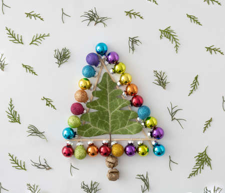New Year's tree with golden decorations on a purple background. Minimal Christmas idea.の写真素材