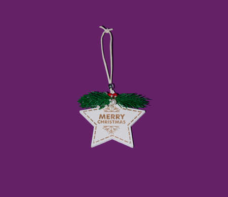 New Year's tree with golden decorations on a purple background. Minimal Christmas idea.の写真素材
