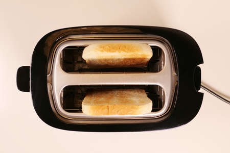 Close up of toaster with two slices of toastの写真素材