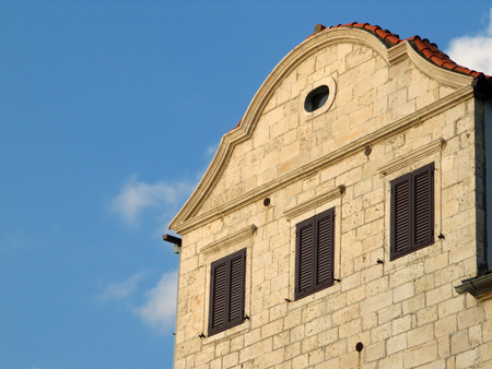 Closed shades on an old stone palace with nice blue sky in the background.の写真素材