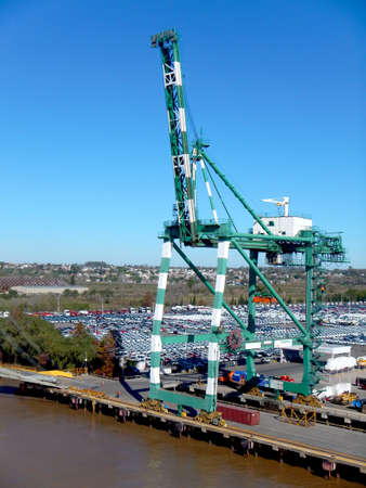 Container terminal, gantry and muddy river water with nice bue sky in the backgroundの写真素材