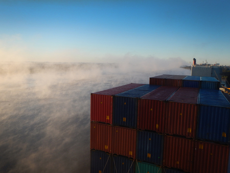 Foggy and cold morning in the port,loaded containersの写真素材