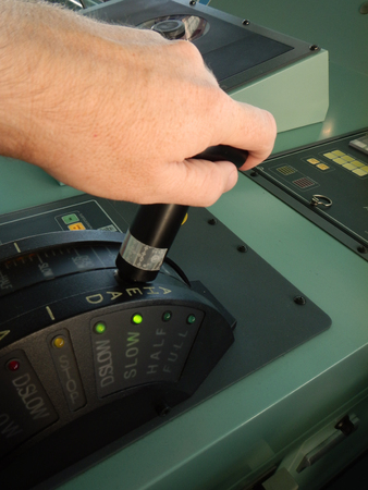 Hand on a ship's telegraph, increasing the speedの写真素材