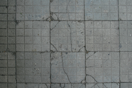 Old floor tiles, cracked and dirtyの写真素材