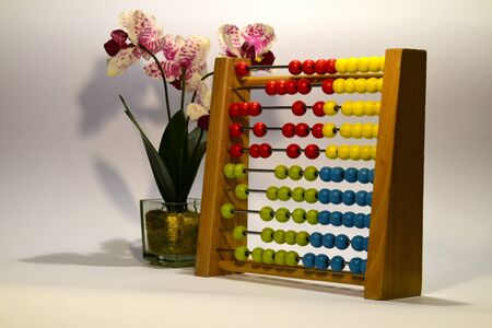 Vintage style Abacus with a beautiful orchid as decoration.の写真素材