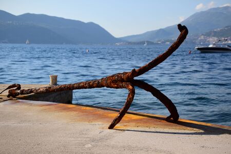 Old rusty anchor left ashore as tourist attraction. One fluke is missing.の写真素材