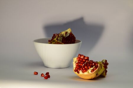 Pomegrenate cut in half with few seeds. Concept for healthy food publications, magazines and brochures.の写真素材
