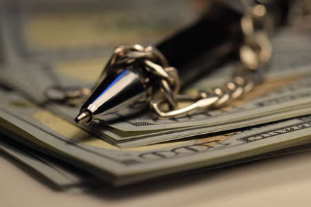 Balloon covered with chain on a pile of money. Concept for freedom of speech, journalism, corruption.の写真素材