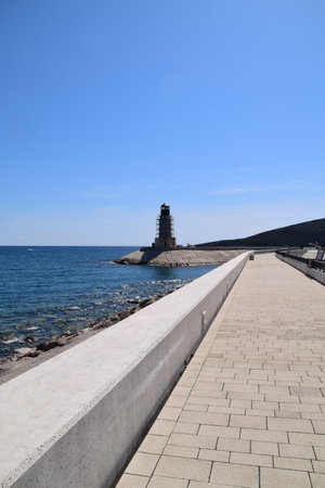 Building a new light tower at the entrance to the luxury marina. Tower is surrounded with stage or scaffoldings.の写真素材