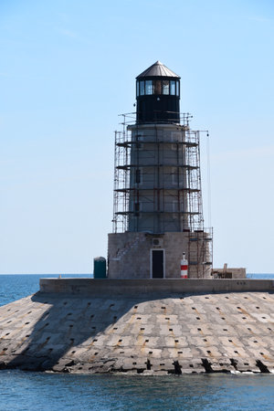 Building a new light tower at the entrance to the luxury marina. Tower is surrounded with stage or scaffoldings.の写真素材