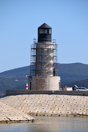 Building a new light tower at the entrance to the luxury marina. Tower is surrounded with stage or scaffoldings.の写真素材