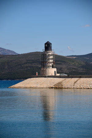 Building a new light tower at the entrance to the luxury marina. Tower is surrounded with stage or scaffoldings.の写真素材