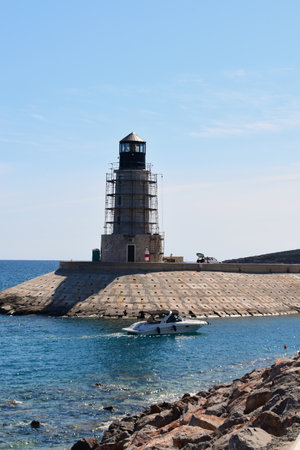 Building a new light tower at the entrance to the luxury marina. Tower is surrounded with stage or scaffoldings.の写真素材