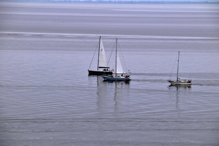 Three sailboats in the sea, North Sea, Lower Saxony, Germany.の写真素材