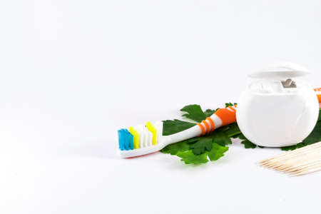 Toothbrush and dental floss on white backgroundの写真素材