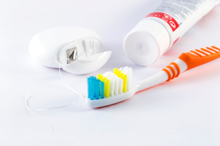 Dental care - toothbrush, toothpaste and dental floss on white background.