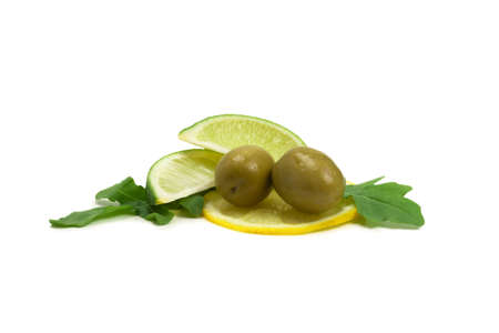 Two olives, piece of lemon and leaves of arugula isolated on whiteの写真素材
