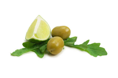 Two olives, piece of lemon and leaves of arugula isolated on whiteの写真素材