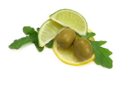 Two olives, piece of lemon and leaves of arugula isolated on whiteの写真素材