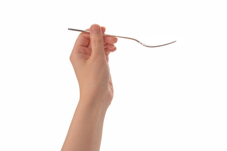 Fork in woman hand isolated on white.の写真素材