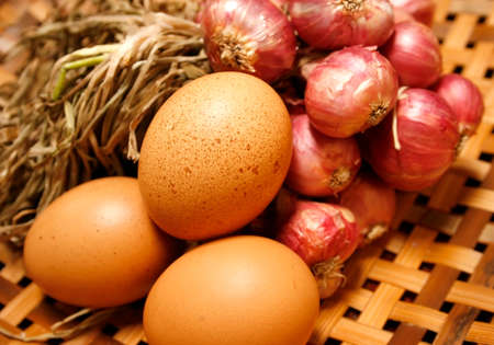 egg and Shallot onions in a group on woodenの写真素材