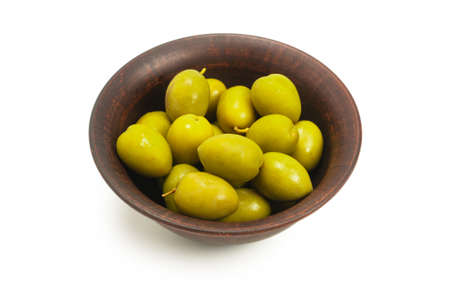 Olives in ceramic brown bowl isolated on whiteの写真素材