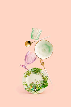 Contemporary still life composition with balancing dishes on pale pink backgroundの写真素材