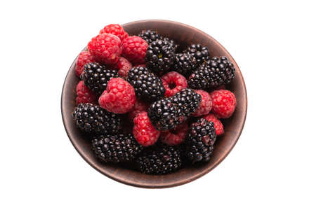 Raspberry, berry and mint leaf in ceramic brown bowl isolated on whiteの写真素材