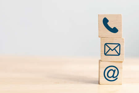 Wooden block cube symbol telephone, email, address. Website page contact us or e-mail marketing conceptの写真素材