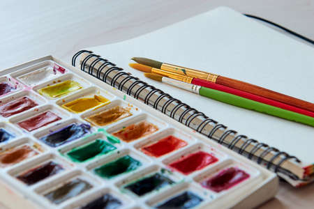 Art supplies brushes, watercolor paints, sketchbook. Artists workplace. Creative Drawing workshop.の写真素材